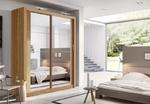 Sliding wardrobe with light wood frame and glass doors, shown in a bedroom setting.