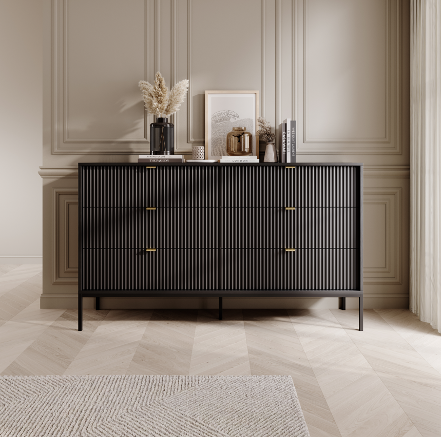 Ridge chest of drawers in black with vertical ribbed fronts and brass-tone bar handles.