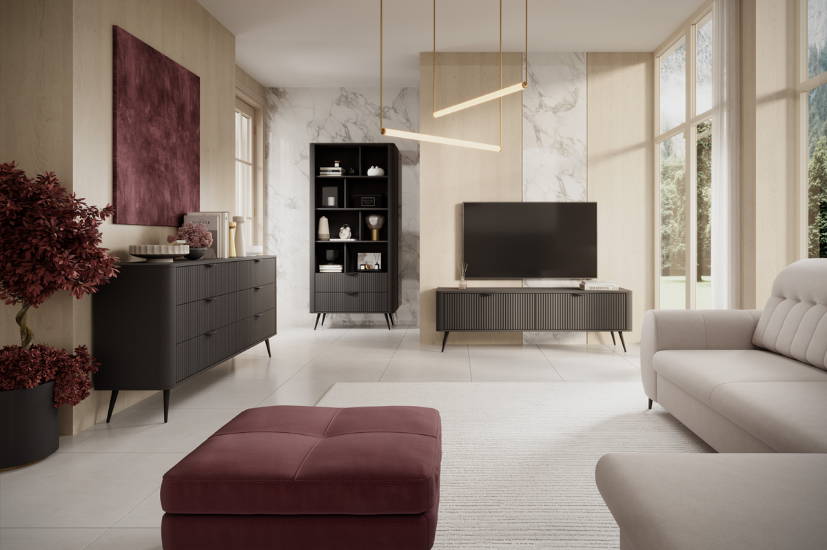 Black tall bookcase with open shelves and ribbed lower cabinet, in a lounge