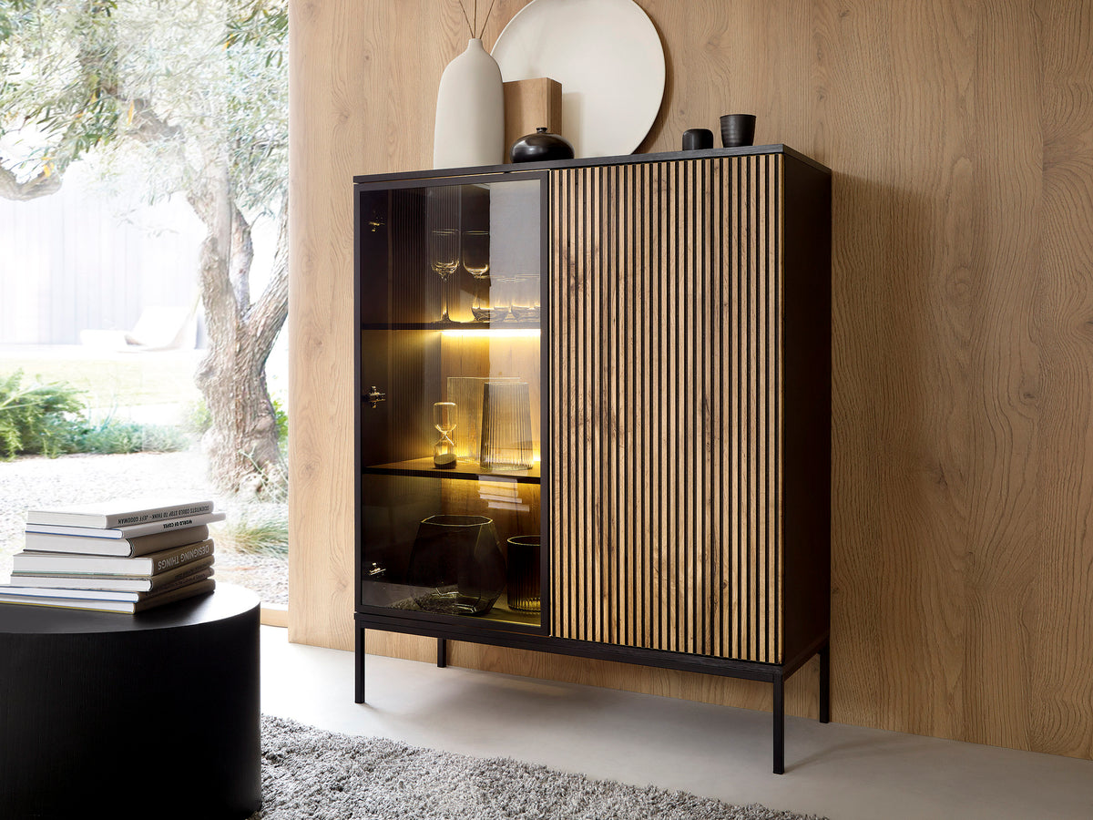 Short display cabinet with glass door, vertical ribbed panel, and warm LED lighting