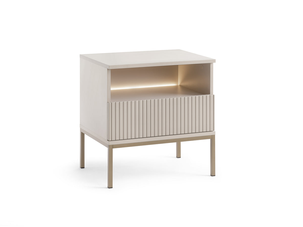 White bedside table with ribbed drawer front and illuminated open storage