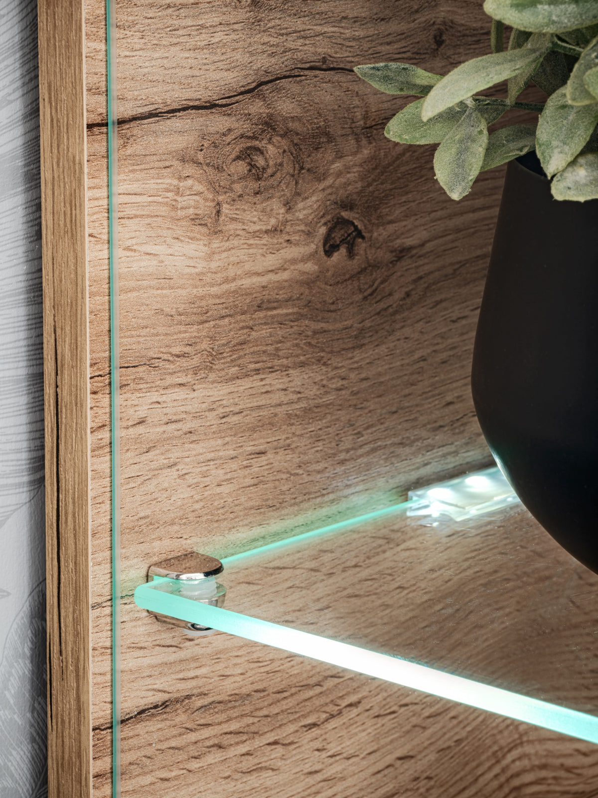 Wood cabinet interior with glass shelf and cool LED light strip