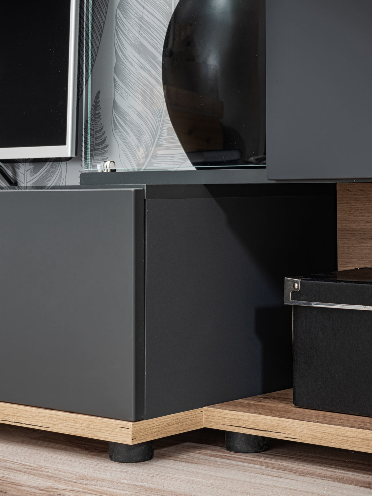 Gray media cabinet base with hinged drawer, wooden legs, and visible hardware