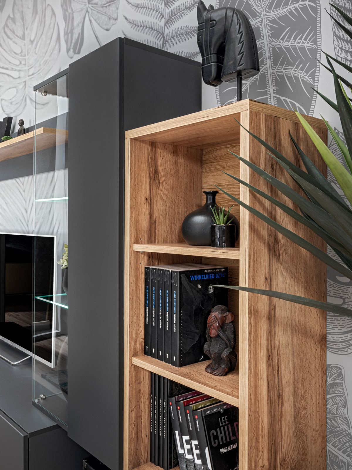 Wood and gray media cabinet with glass shelves and vertical book storage section