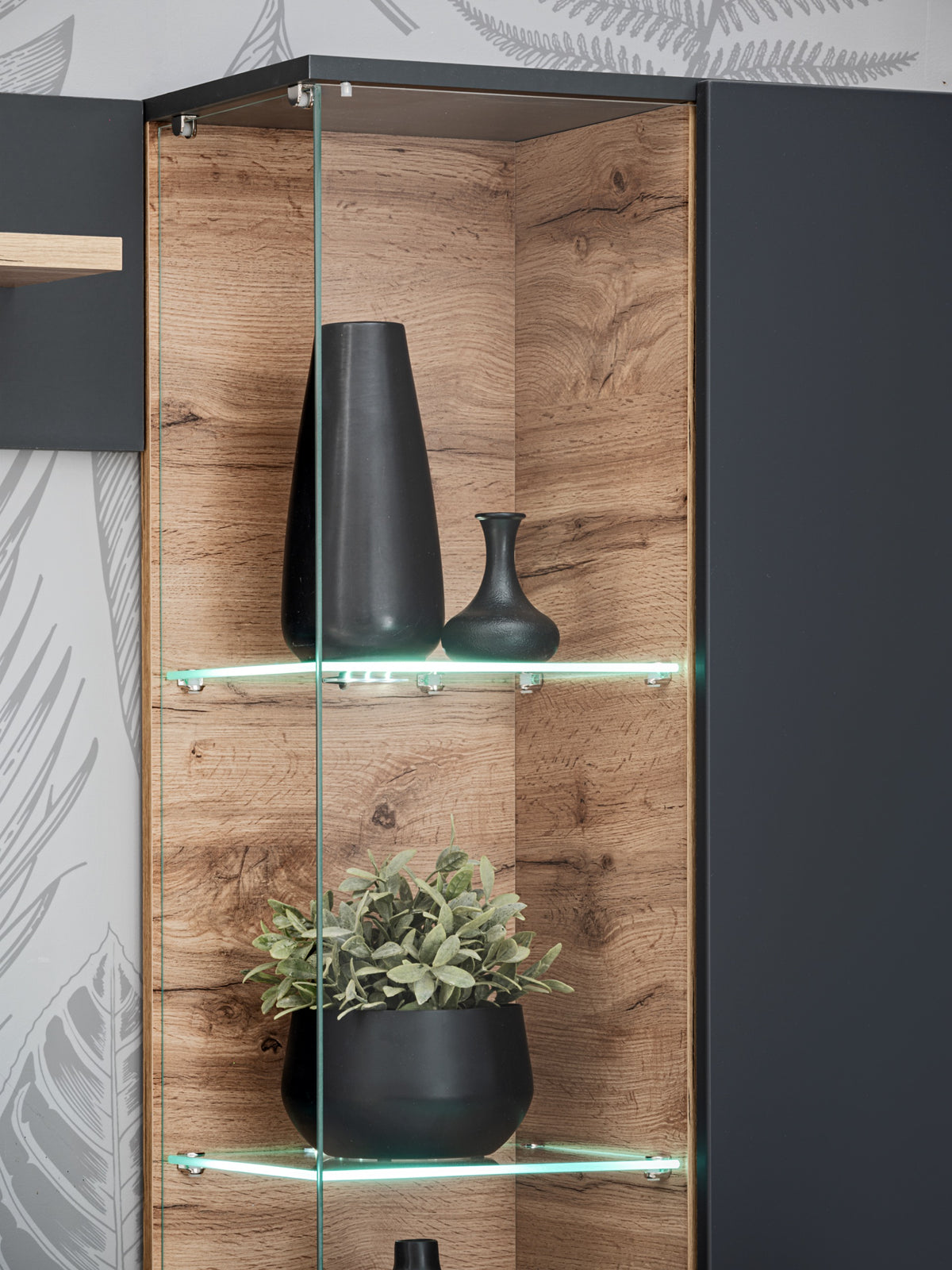 Glass-front display cabinet with wooden backing, vases, and integrated LED strips