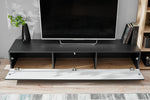 Anthracite media wall unit with swing-down drawer panel open showing cable holes