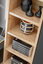 Anthracite media wall unit open shelving with vases and stacked books