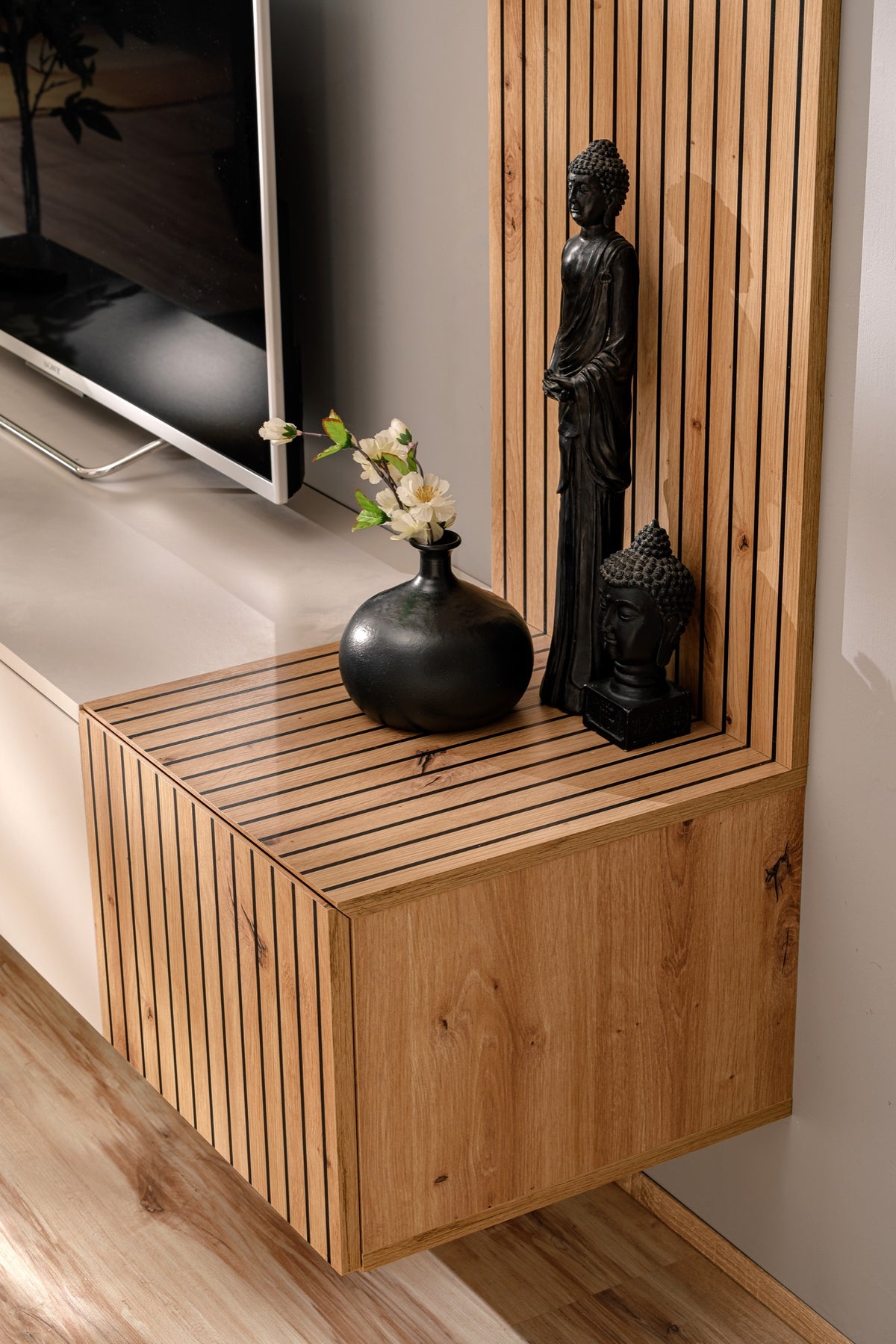 Corner media wall cabinet with open top ledge, wood box base, and vertical slat panel