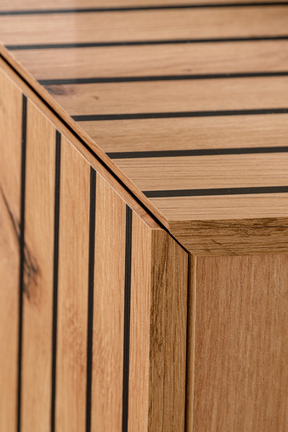 Wood wall unit side panel with vertical slatted trim and warm oak-toned finish