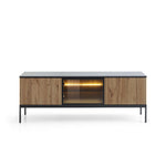 TV cabinet with black top, vertical oak slat doors, glass center opening and warm light
