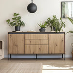 Wood 4-door sideboard with ribbed panels, center drawer, and black legs.