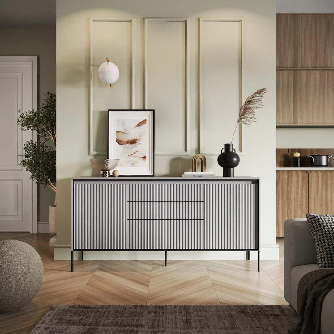 Light sideboard with vertical ribbed doors and three drawers, black metal legs.