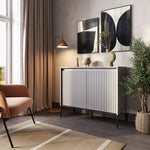 Two-door sideboard with vertical slats on doors, white top, black metal feet, warm wood color.