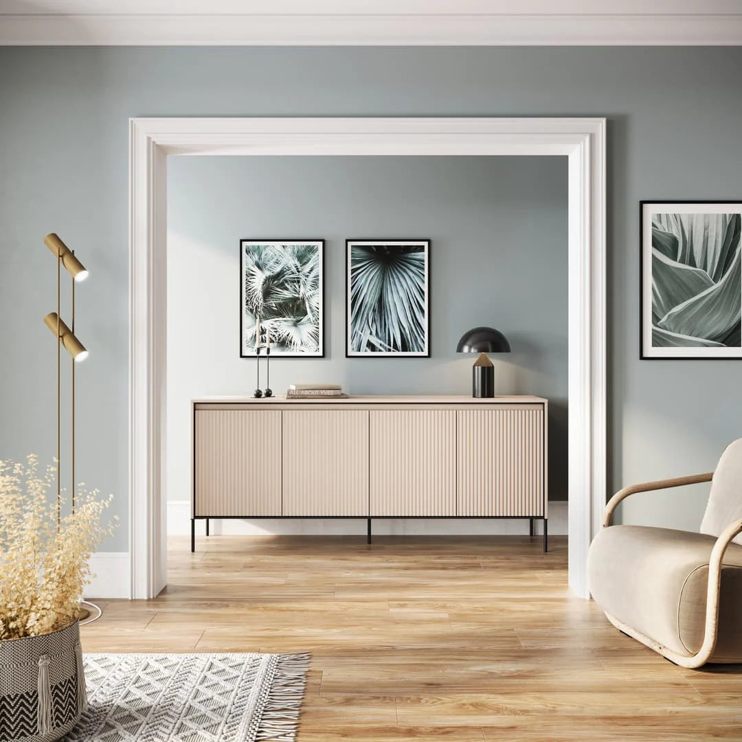 Beige 4-door sideboard with fluted doors and black metal legs.