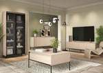 Two-door sideboard with vertical slatted fronts, light beige top, slim black legs.