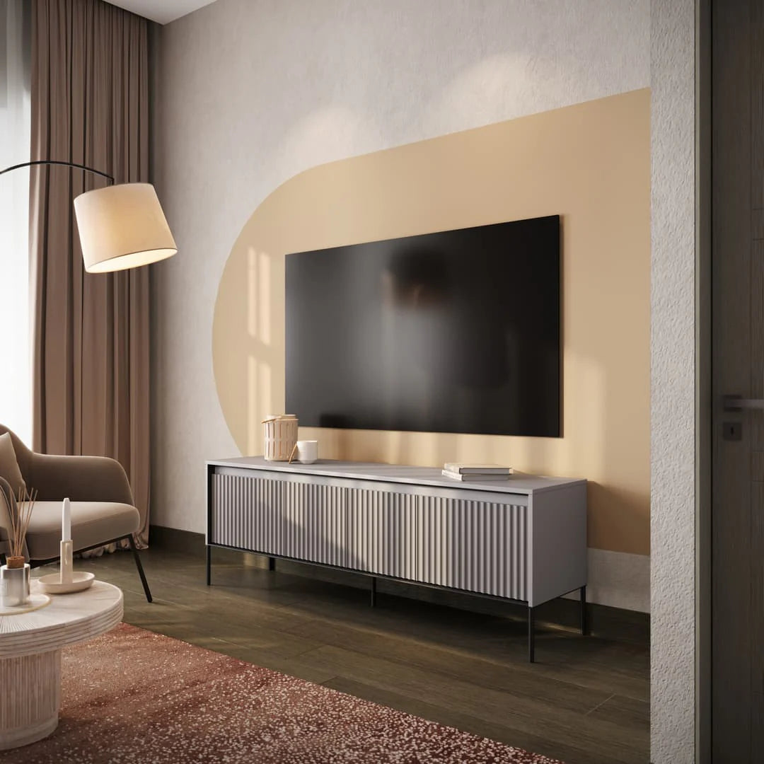 Short TV media cabinet with vertical ribbed doors and slim black metal legs