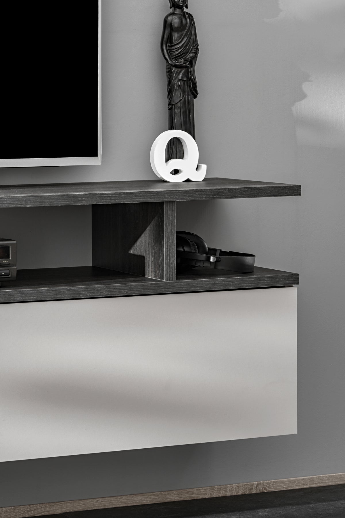 Media wall unit wall shelf with vertical divider and decorative Q item on top