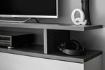 Media wall unit with open shelves, dark side panels, and a speaker and AV devices
