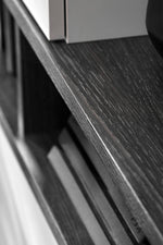 Dark wood media wall unit top shelf with angled edge and textured grain detail