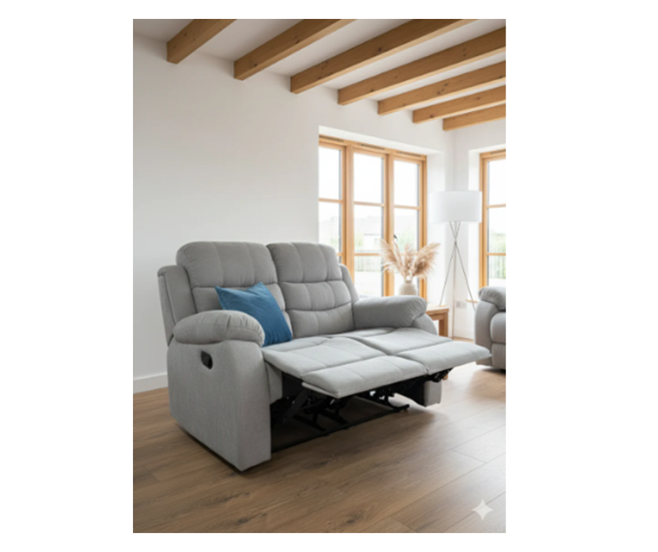 Gray fabric manual recliner with blue side pillow and extended footrest.