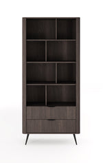 Tall dark wood bookcase with open cubby shelves and bottom drawer with panel fronts