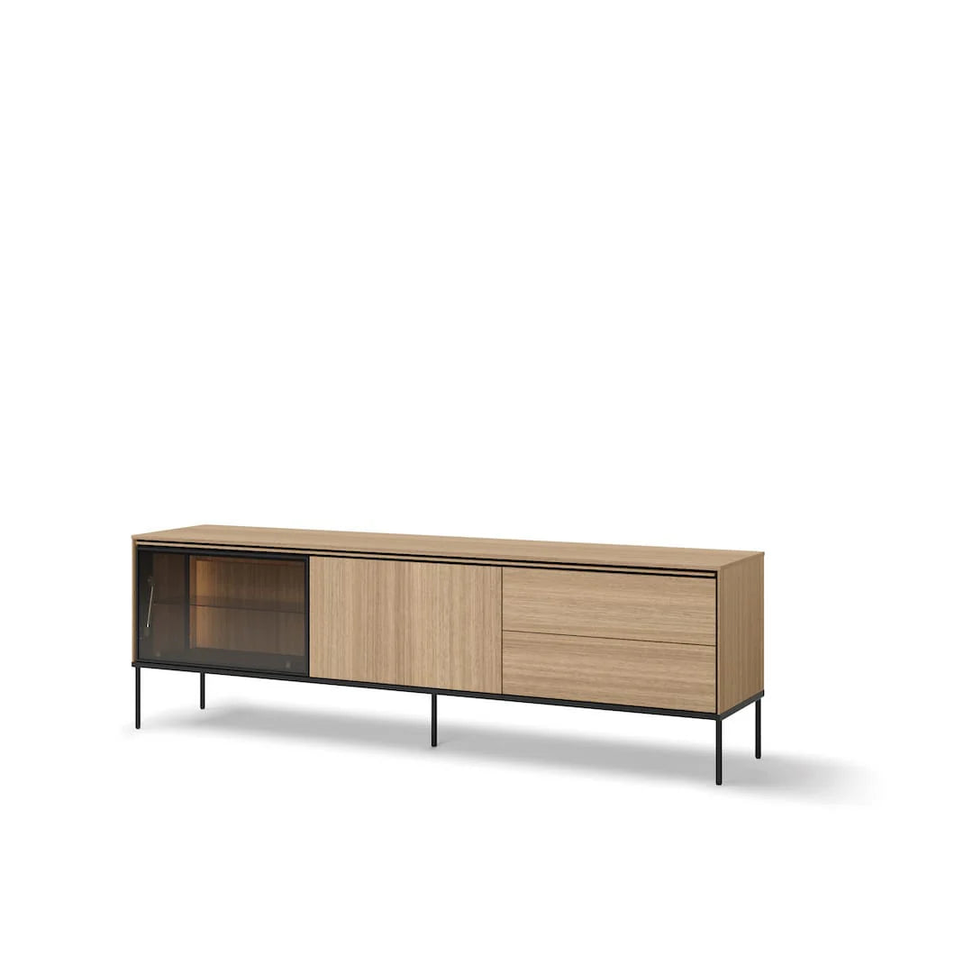 Light wood TV cabinet with dark glass door, two drawers, and black metal legs