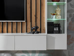 Media wall unit close view of white console, wood slat panel, and lit glass cabinet