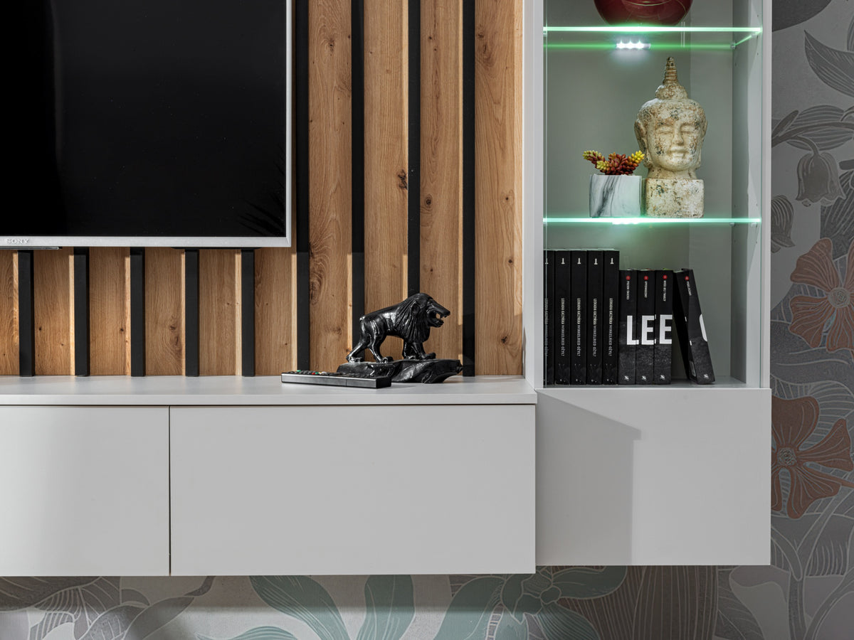 Media wall unit close view of white console, wood slat panel, and lit glass cabinet