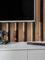 TV wall unit with vertical wood slat back and white low storage cabinet