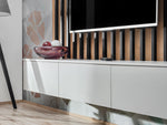 TV wall unit with vertical wood slats, white cabinet doors, and open top shelf