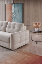 Beige 3-seater sofa bed with curved arms and tufted seat cushions