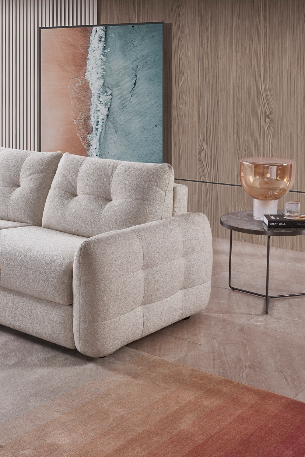Beige 3-seater sofa bed with curved arms and tufted seat cushions