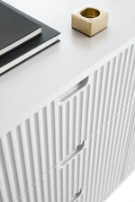 Mila TV cabinet close-up with white fluted door panels and minimal tabletop top.