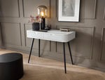 Cashmere dressing table with striped drawer front and black tapered legs against wall panels