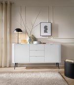 White ribbed sideboard with two drawers and two cabinet doors on tapered legs