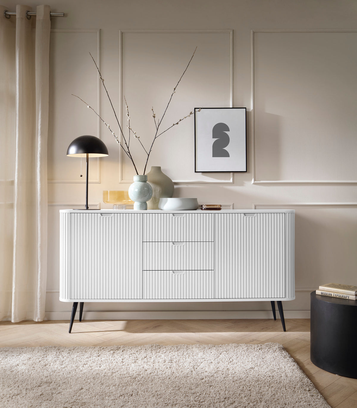 White ribbed sideboard with two drawers and two cabinet doors on tapered legs