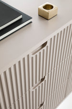 Mila TV cabinet with white fluted panel doors and smooth top surface.