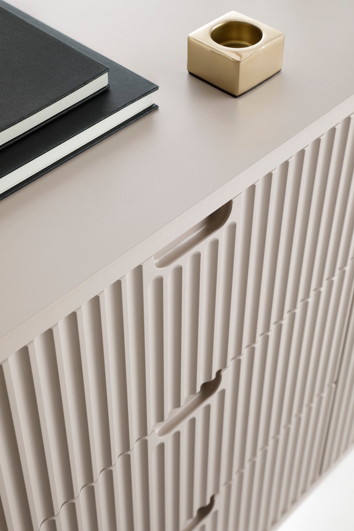 Mila TV cabinet with white fluted panel doors and smooth top surface.