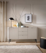 Cashmere ribbed sideboard with three drawers and slim cabinet doors on black legs