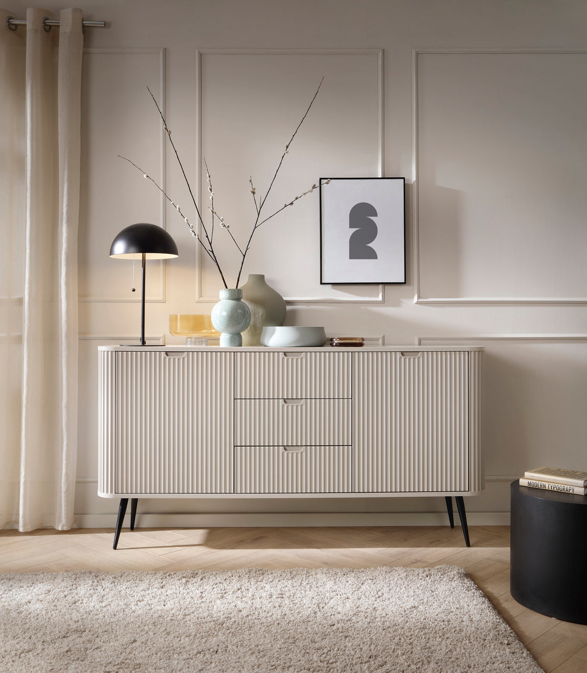 Cashmere ribbed sideboard with three drawers and slim cabinet doors on black legs
