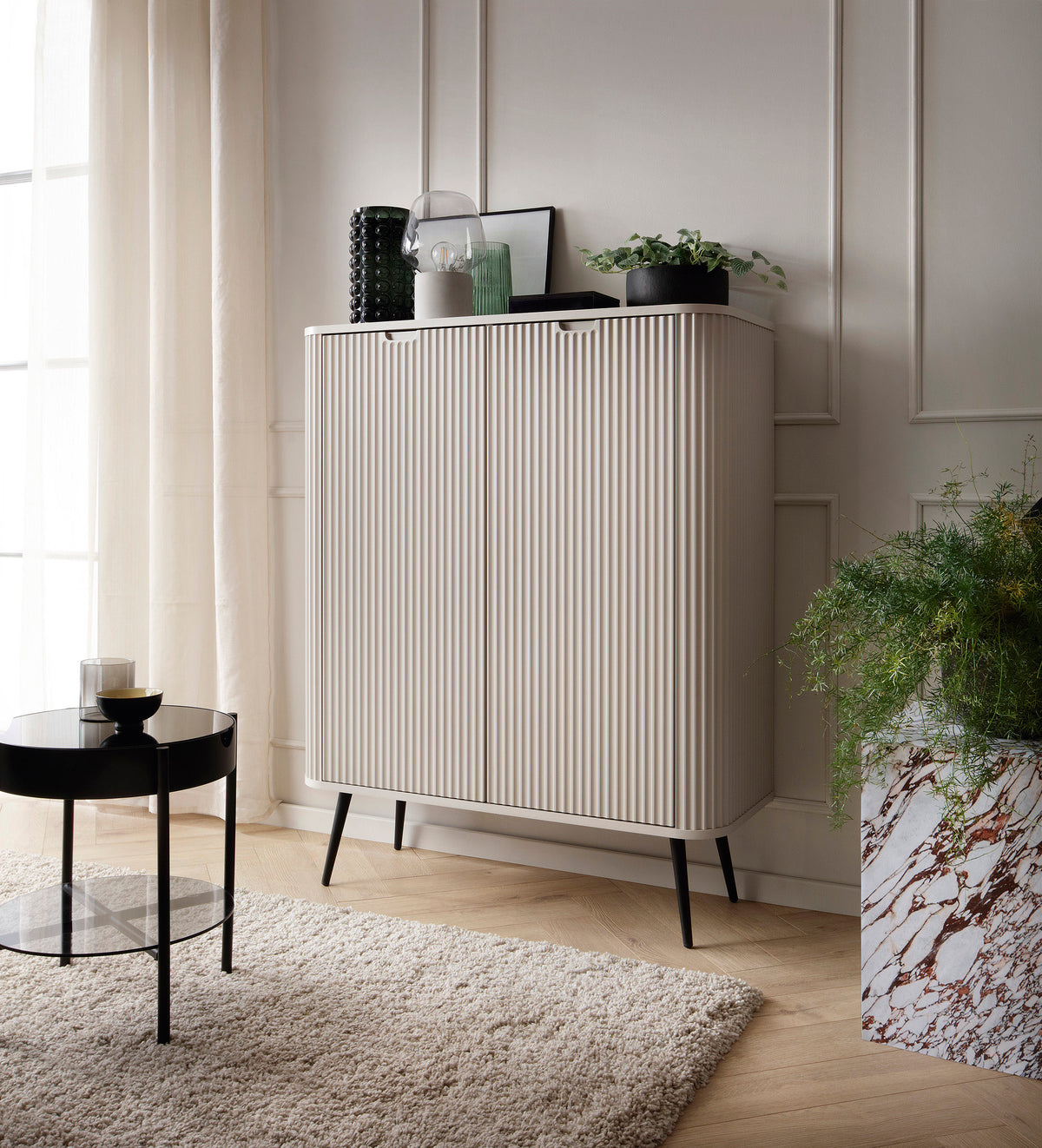 Cashmere highboard cabinet with vertical ribbed doors and tapered legs in a living room