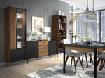 Tall bookcase with open shelves, vertical door panels, and lower drawer cabinets