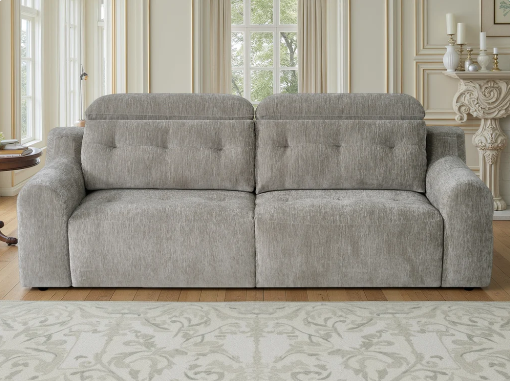 Light gray electric sofa with tufted back and seat cushions, wide arms, front view.