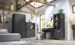 Black dressing table in a styled room with woodgrain top, drawer, and open shelf